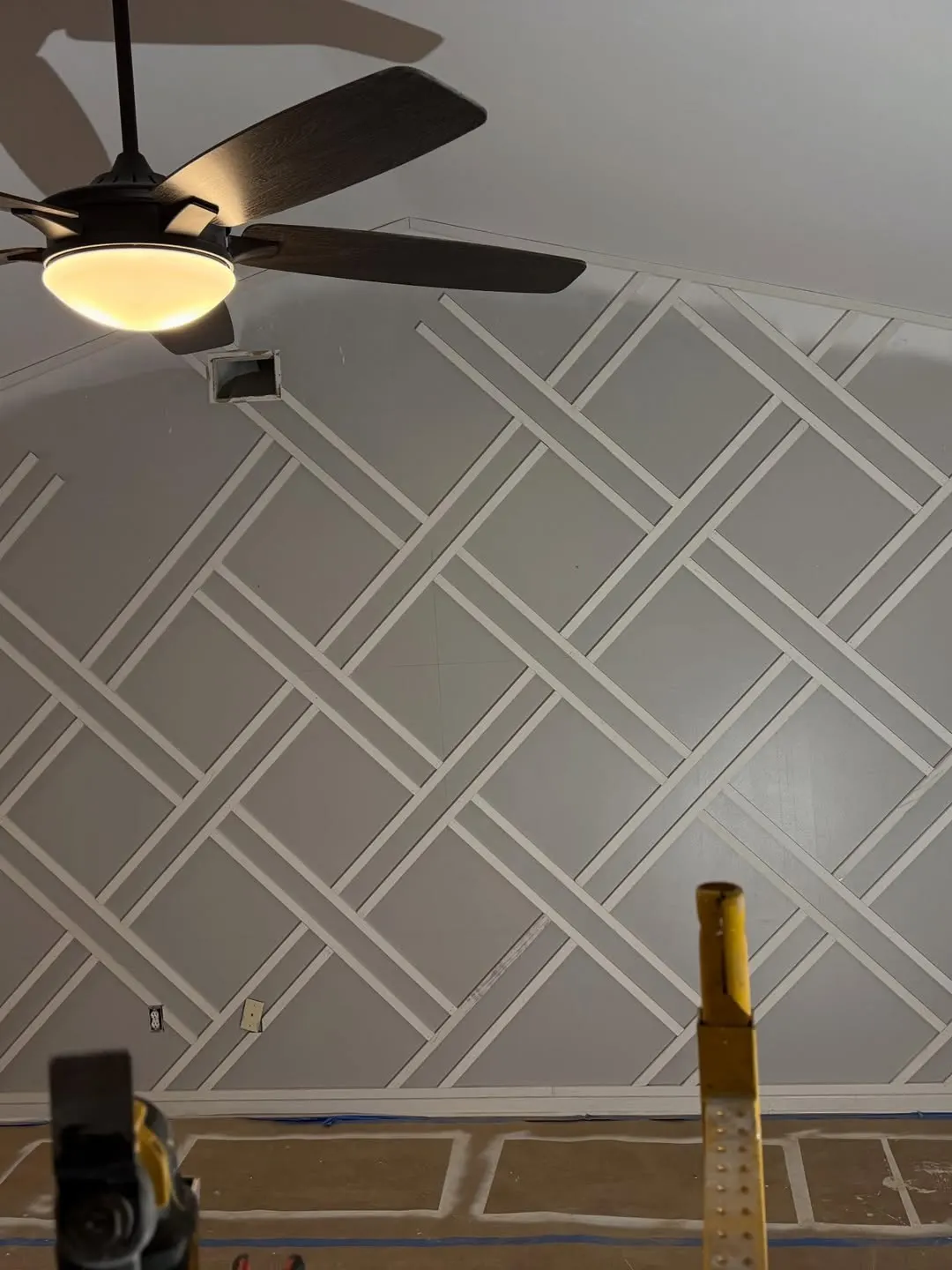 Diagonal lattice trim finished on a gray wall
