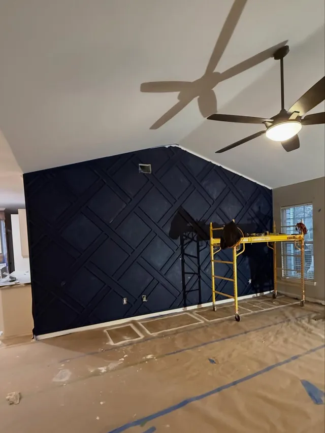 Accent wall with diagonal lattice trim painted navy blue