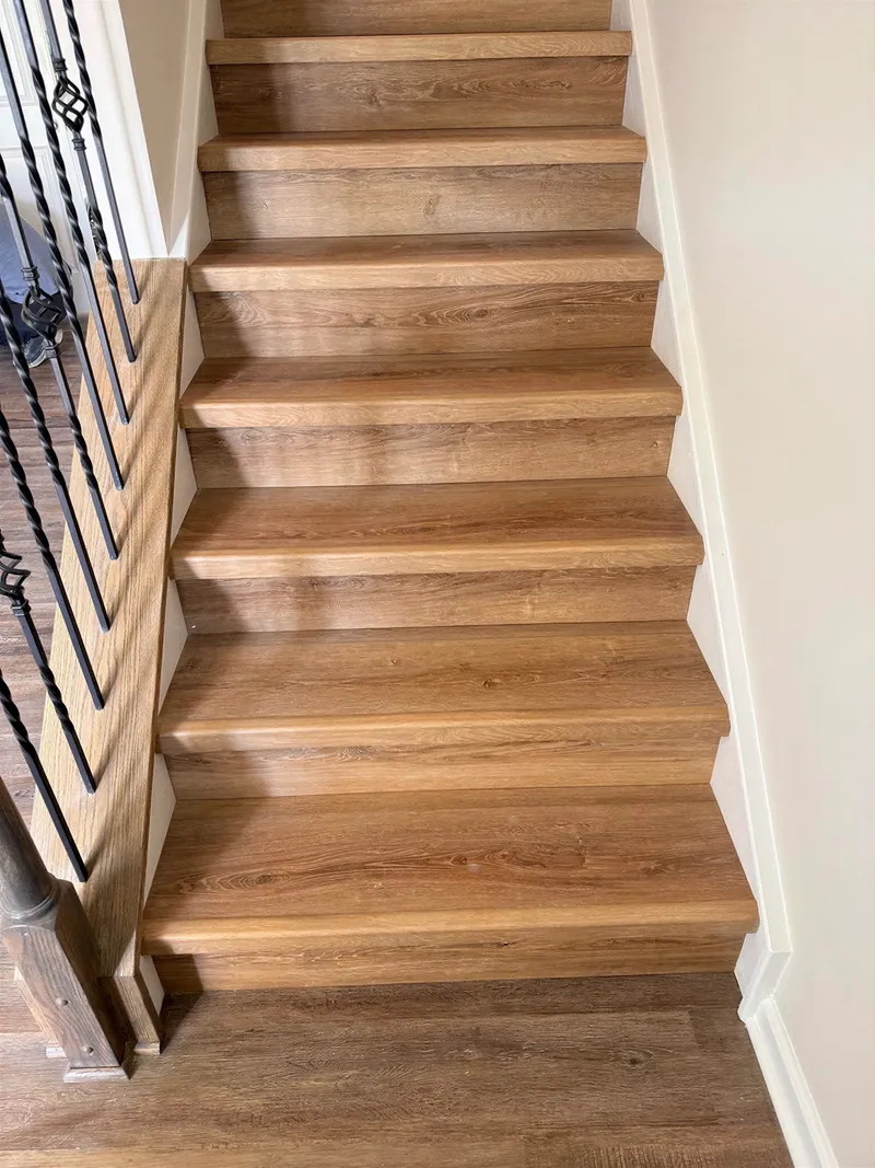 Close-up of vinyl plank stair treads with matching rounded stair nose