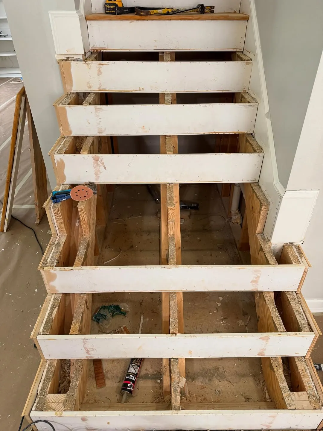 Staircase stripped to the framing before new treads
