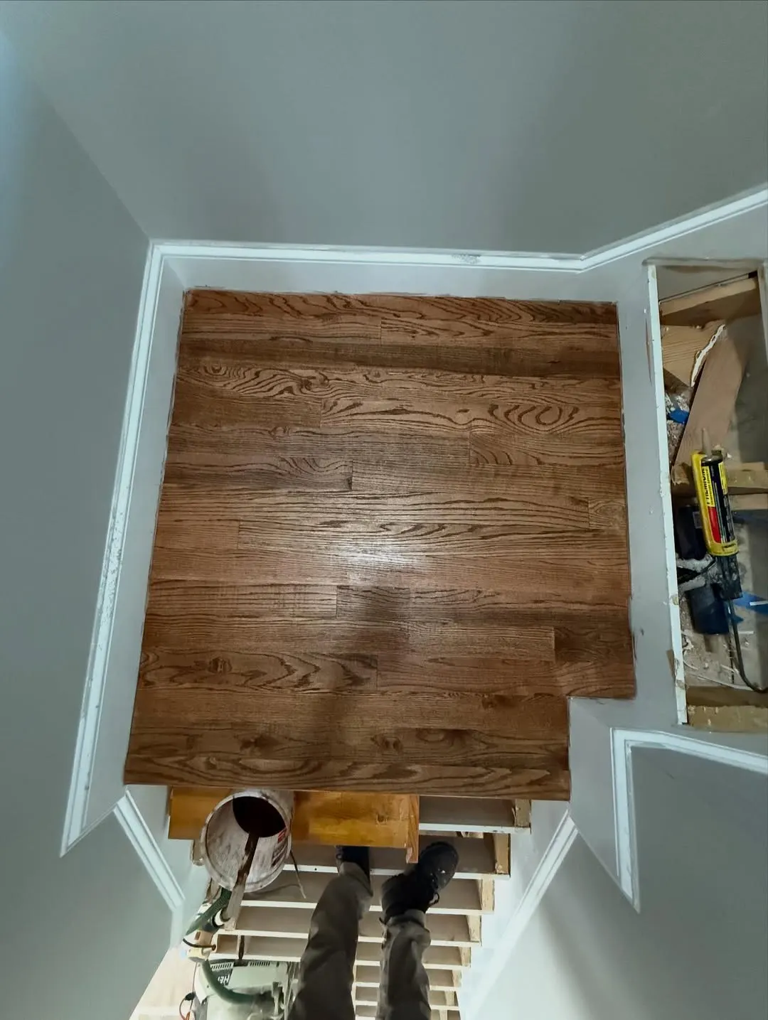 Stair landing in stained oak seen from above